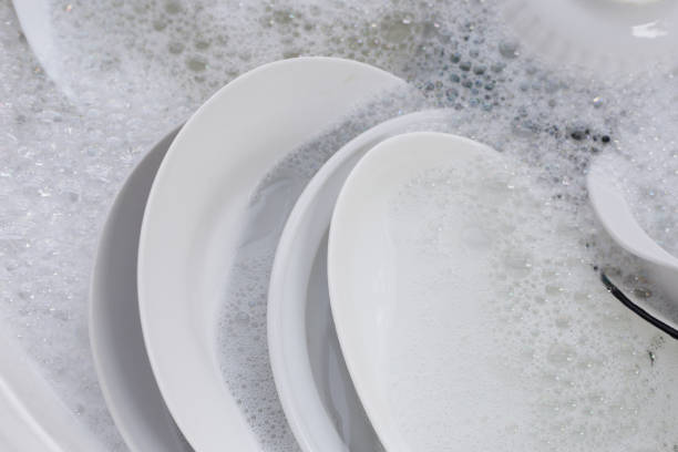 istock Dish washing, Dirty plates and bowls soaking in kitchen sink. 1926834021