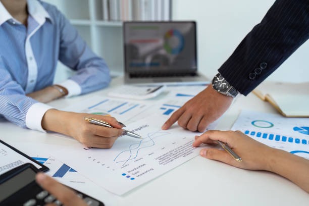 istock accountant with laptop and paperwork analyzing financial data report 1926871442