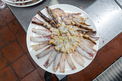 Uncooked king crabs cut and placed on plates