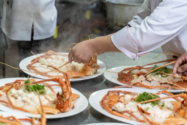 istock The chef's hand is operating the cooked lobster on the plate 1926884293