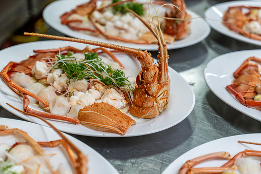 Red lobsters placed on white plates after cooking