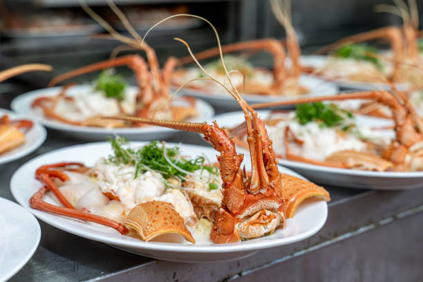 Red lobsters placed on white plates after cooking