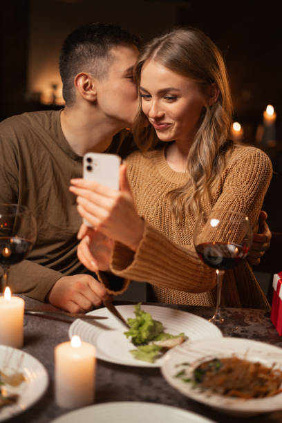istock Young couple in love having dinner at restaurant romantic date taking selfie using smartphone 1926891714