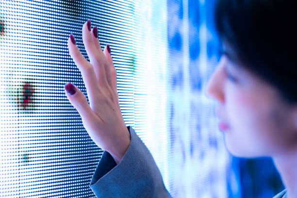 Focus woman hand touching blue digital screen with blur face background.