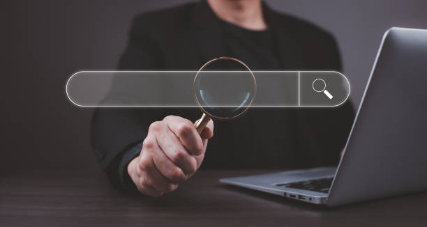 istock Searching Browsing Internet Data Information with blank search bar. man hold magnifying glass to Searching for information. Using Search Console with your website. 1926919260