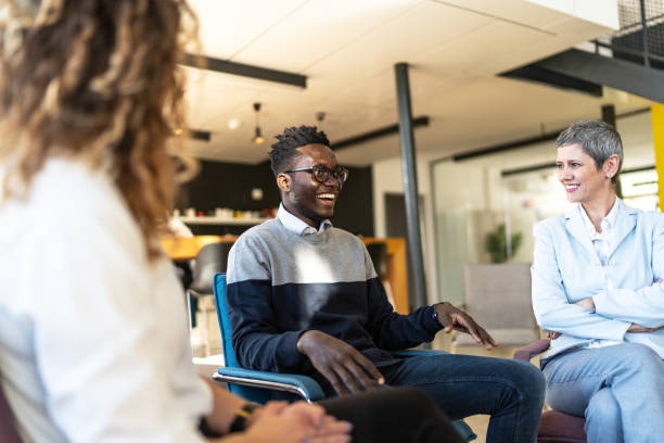 istock An adult man, looking happy, talking with random people from the group therapy 1926944408