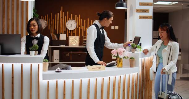istock Hotel guest arriving at reception to do check in process 1926953854