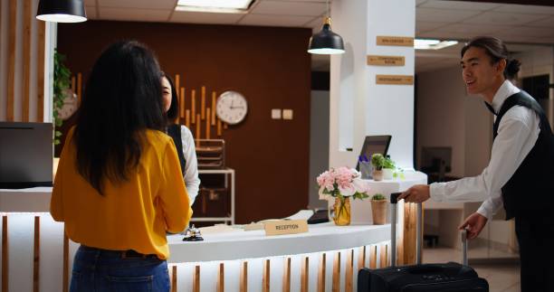istock Hotel guest calling upon front desk staff to give assistance 1926954914