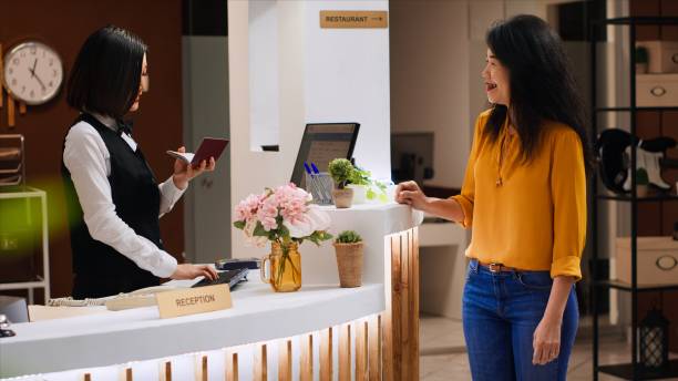 istock Hotel worker looking at passport id for check in process 1926962305