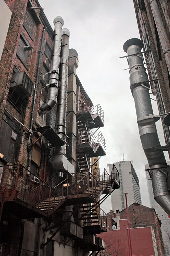 Chinatown is a small area of Manchester's city centre.  Being in the city centre, the area is entirely urbanised.  These open iron ladder fire escapes and large air-ducts are typical of this inner city area.