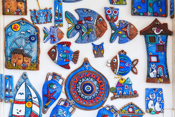 Handmade creative magnets: evil eye, fish, cats, owls, houses. Ceramic, blue, vibrant colors. Various colorful fridge magnets to remind travel. October 14, 2023. Bodrum, Turkey (Turkiye)