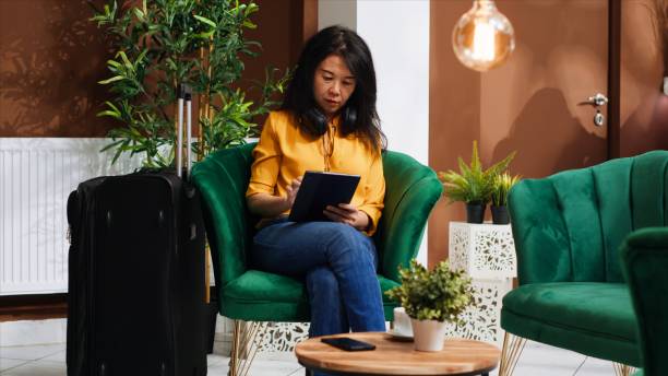 istock Young traveler using tablet in lounge area at hotel 1926979258