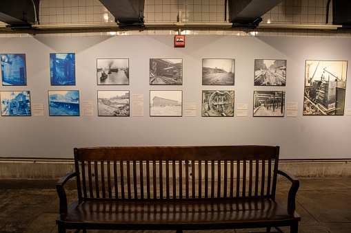 nyc, United States – January 07, 2024: A collection of vintage photos on a tiled wall of the New York subway