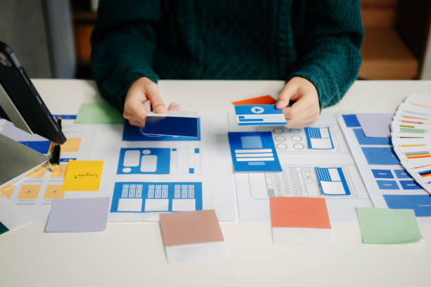 istock View of UI developer team brainstorming on their project with laptop, smartphone and digital tablet. Creative digital development agency. 1926991562