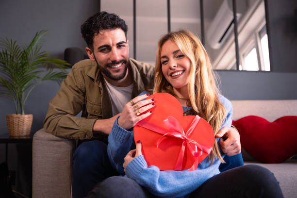 istock Loving young couple with heart-shaped gift box. Valentine's Day Celebration. 1926999549