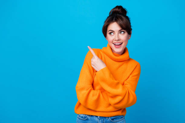 istock Photo of dreamy excited lady wear knitted pullover pointing finger looking empty space isolated blue color background 1927004801