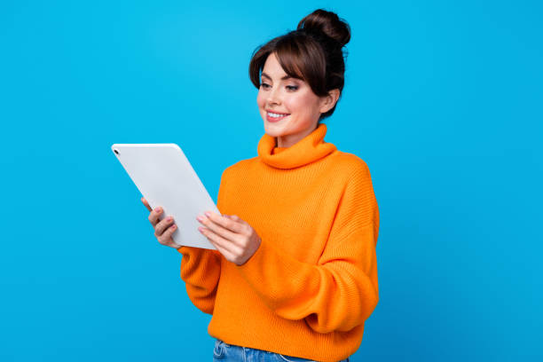 istock Photo of pretty shiny lady wear knitted pullover communicating modern gadget isolated blue color background 1927020121