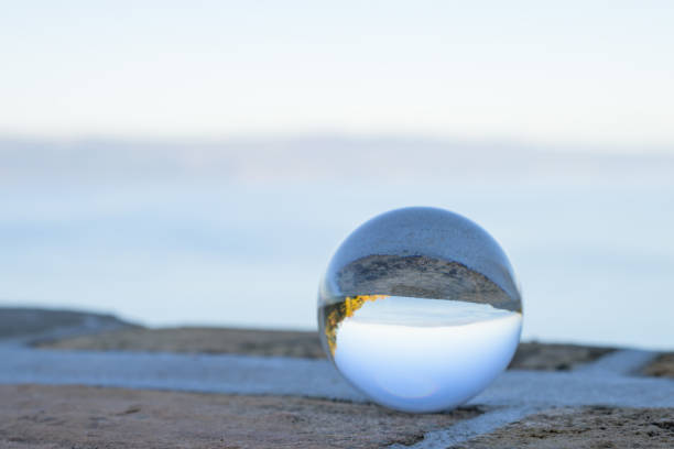 Glass ball lying on a stone wall, sunny day in autumn in Cres (Croatia)