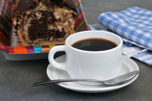 Breakfast with coffee and homemade cake Cup of coffee with a spoon and a marble cake tasse café stock pictures, royalty-free photos & images