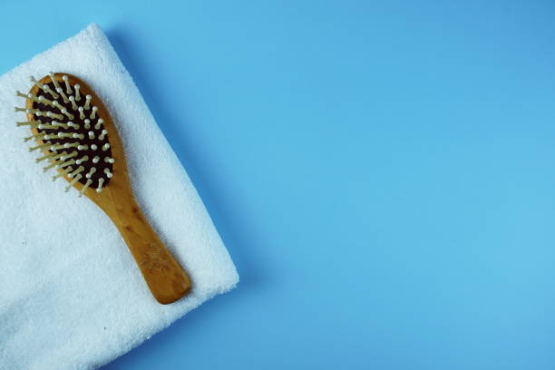 istock Wooden Comb and towel on blue background 1927044896