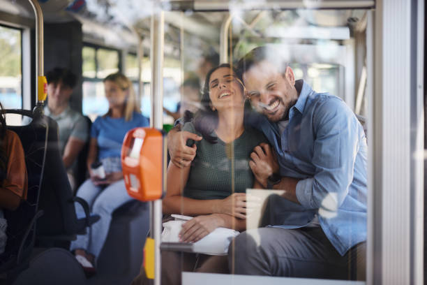 istock Cheerful couple embracing while traveling by a bus. 1927066684