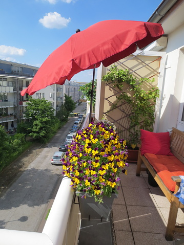 Balcony in summer with flowers and parasol