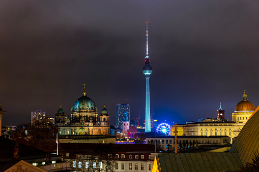 Berlin, Germany - December 16th 2023: the illuminated skyline of Berlin-Mitte with Dome, Fernsehturm, City Palace and Red Cityhall during winter night time