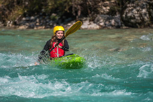 Close-up of reef with group of young people are rafting on the river, at tourist attraction.