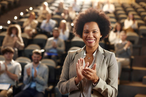 istock Happy black public speaker applauding on successful education event. 1927117052