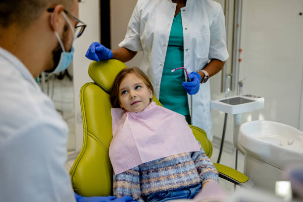 istock Diverse dental professionals with young patient 1927155214