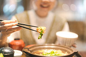 Asia tasty closeup hand with chopstick and tonkatsu miso menu eating food at Japanese restaurant
