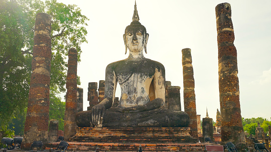 Wat Mahatat temple, Sukhothai historical park, Sukhothai, Thailand. Ancient buddha statue at Wat Mahathat temple in Sukhothai historical park, Thailand. UNESCO World heritage site
