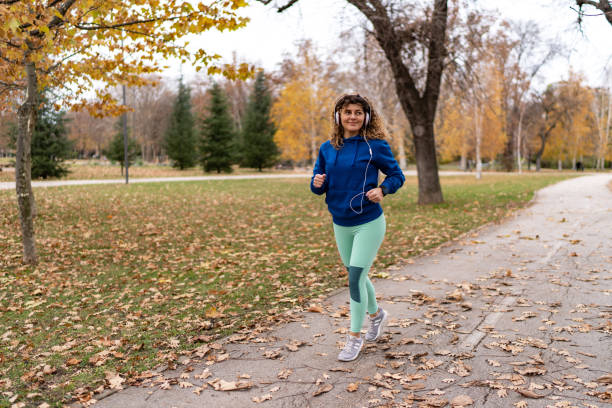 istock Woman running in autumn park 1927184698