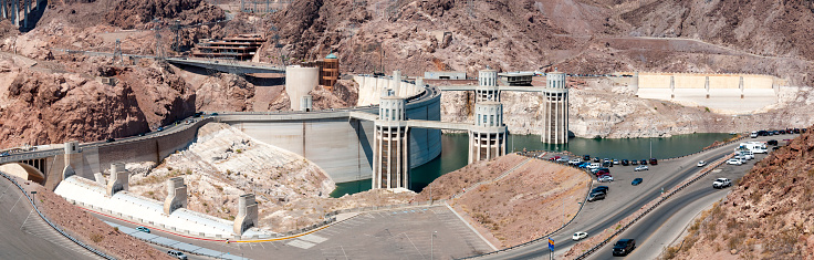 An image of the Hoover Dam, an engineering marvel spanning the Colorado River between Arizona and Nevada. This monumental structure is not only a symbol of human ingenuity but also a striking feature within the stark desert landscape, showcasing the dramatic interplay between nature and technology.