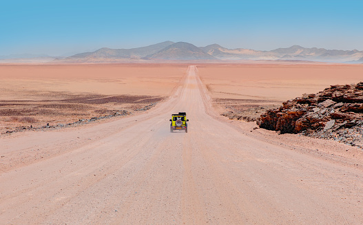 Vehicle rides through the sand dune Namib desert - Namibia
