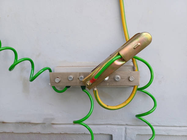 istock Green - yellow wire ground cable clamp, Grounding system installed or mounted to the ground to prevent electrical hazards. 1927200724