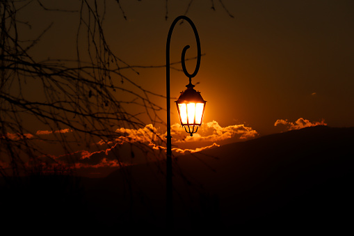 Orange Sunset Lighting Up The Street Lamp