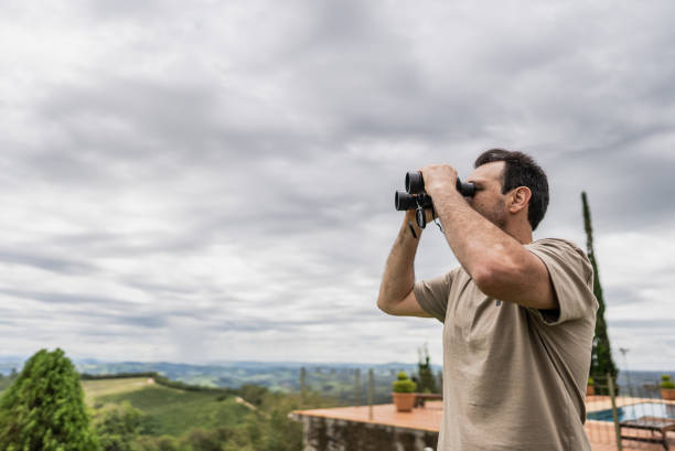 istock Mature man looking at view with a binoculars outdoors 1927223412