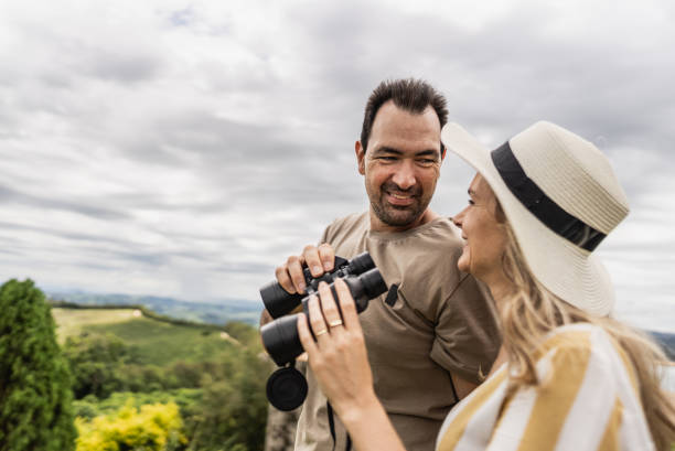 istock Mature couple looking at view with a binoculars outdoors 1927223493