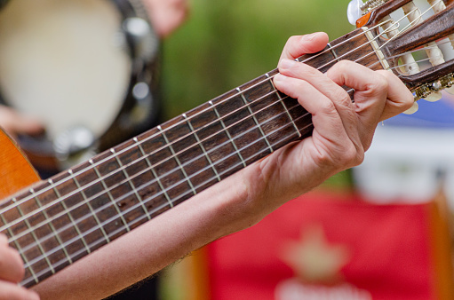 hand of a man playing a Spanish guitar