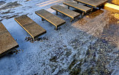 stone walkways over water ponds on metal struts levitate stone slabs over frozen water. garden path in a pond formal or Japanese garden. rectangular slabs of marble, polished