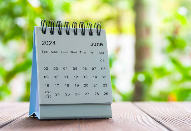 istock June 2024 white table calendar with nature background. Calendar concept. 1927237372