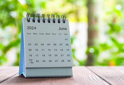 June 2024 white table calendar with nature background. Calendar concept