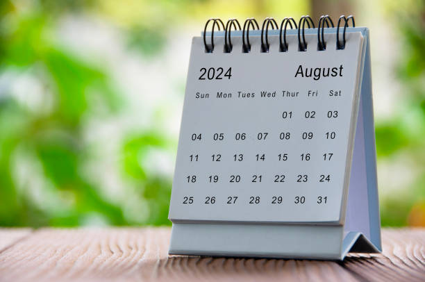 August 2024 white table calendar with nature background. Calendar concept.