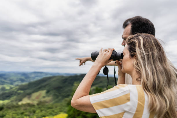 istock Mature couple looking at view with a binoculars outdoors 1927245872