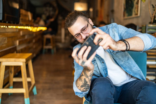 istock Man playing video games on smartphone 1927258687