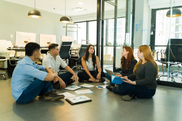 istock Sales team having a meeting with their boss while sitting on the floor 1927267601