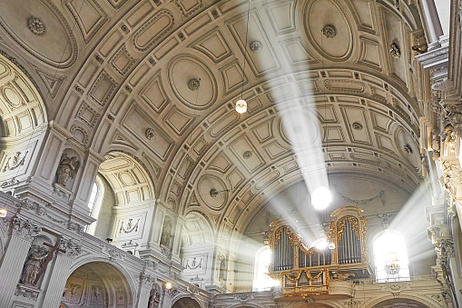 A wide angle photograph of a church organ in natural light