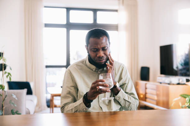 istock African man having toothache from ice cold water 1927275158