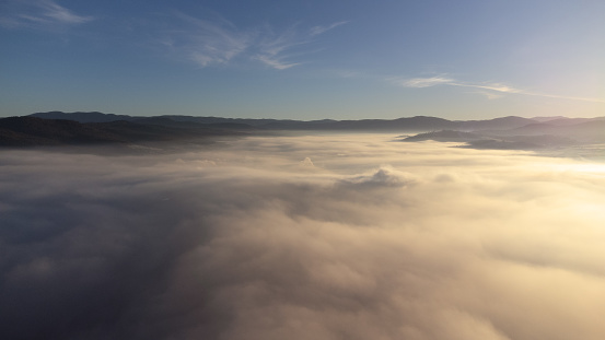 Drone landscape stock photo of a clear skies above the clouds or thick fog